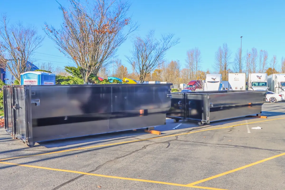 Professional dumpster rental service with roll-off container on residential driveway in Battle Ground
